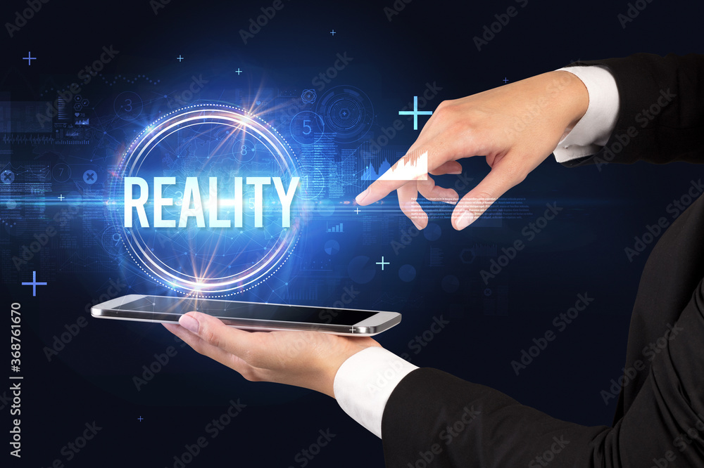 Close-up of a touchscreen with REALITY inscription, new technology concept Close-up of a touchscreen with REALITY inscription, new technology concept