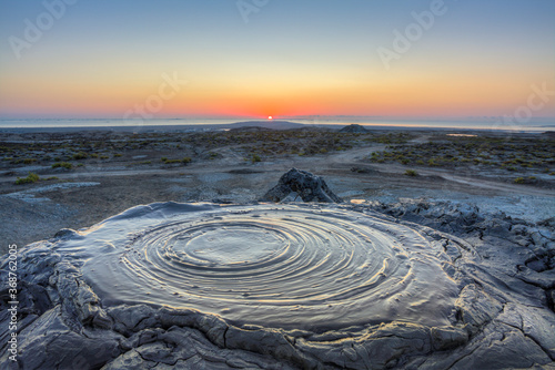 Bubbling crater of a mud volcano. Active mud volcano in Gobustan desert, Azerbaijan photo