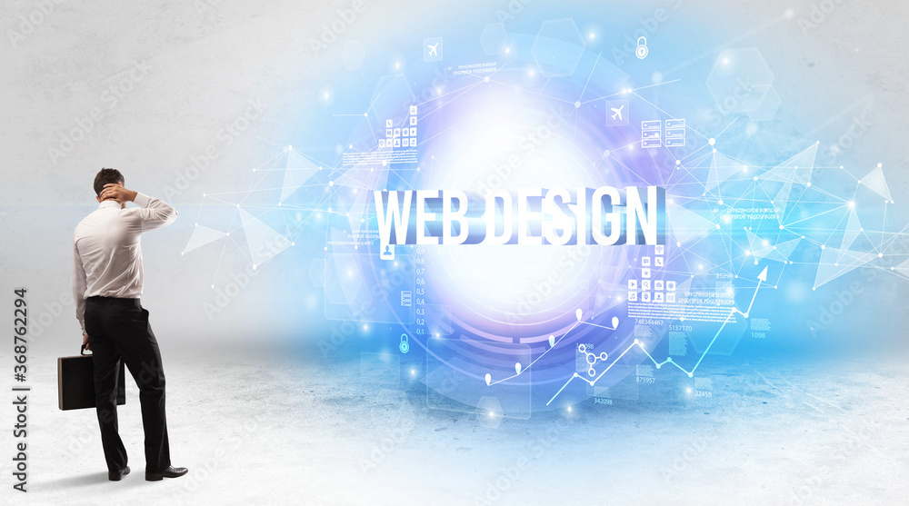 Rear view of a businessman standing in front of WEB DESIGN inscription, modern technology concept Rear view of a businessman standing in front of WEB DESIGN inscription, modern technology concept