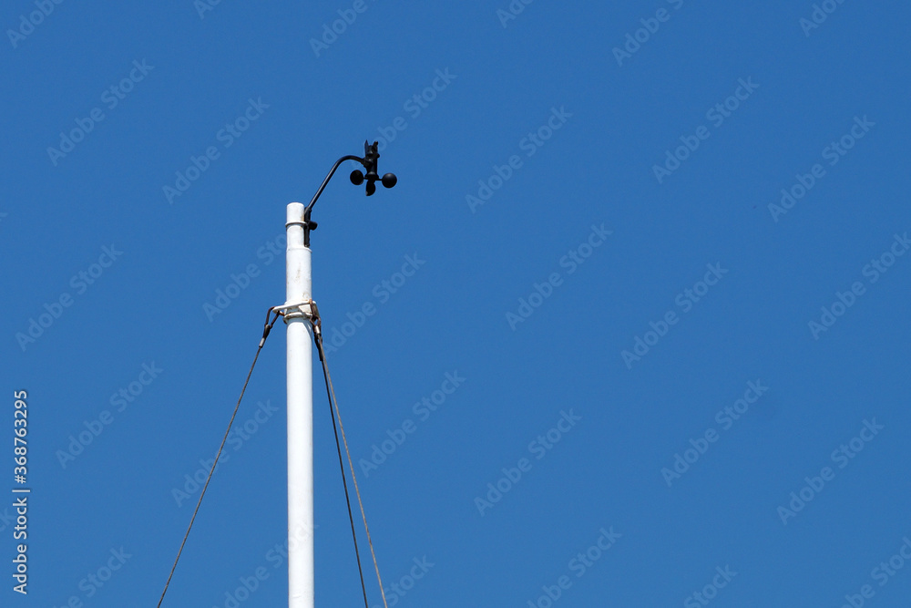 meteorological device for measuring wind speed against a blue sky