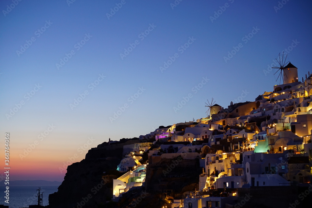 Sunset view and beautiful buildings lighted by sunset in santorini island, Greece, Europe