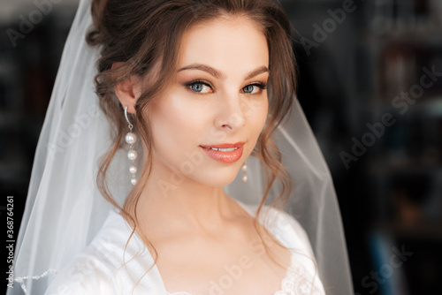 portrait of a beautiful bride with makeup and hair styling smiling