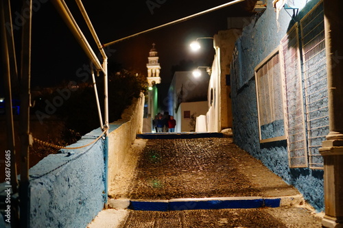 Fototapeta Naklejka Na Ścianę i Meble -  A night narrow street of Santorini island, Greece, Europe