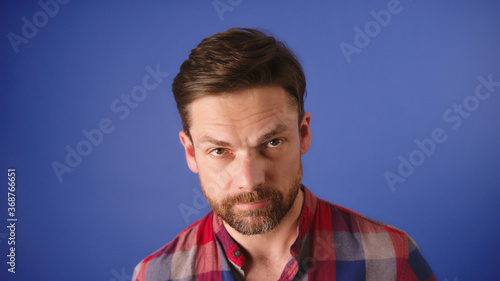 Isolated shot of young handsome male with beard and mustache. Face expression. Copy space. High quality photo