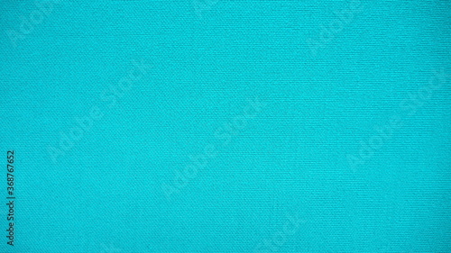 Closeup of beautiful cotton mixed with polyester fabric in bright green and turquoise tone with rough surface and texture for background and decoration. Cool banner on page and cover