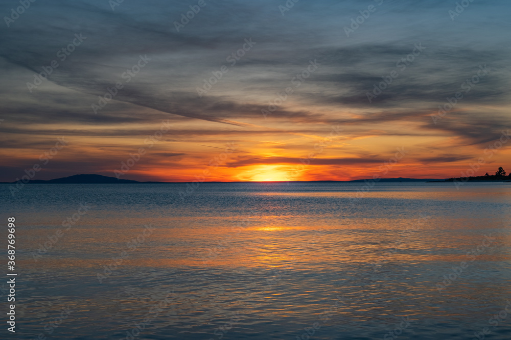 Croatia, island of Pag, beautiful dramatic sunset over Adriatic sea horizon, colorful red sky
