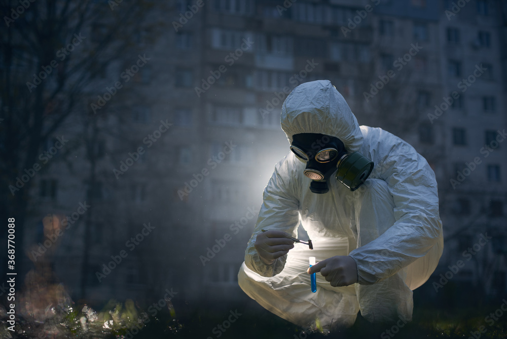 Crouching scientist working outside with fresh samples using laboratory tools and liquids, concept of saving our planet