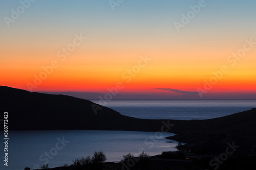 Sunset at Delfini bay, in Syros island, Cyclades, Greece, Europe. © YiannisMantas