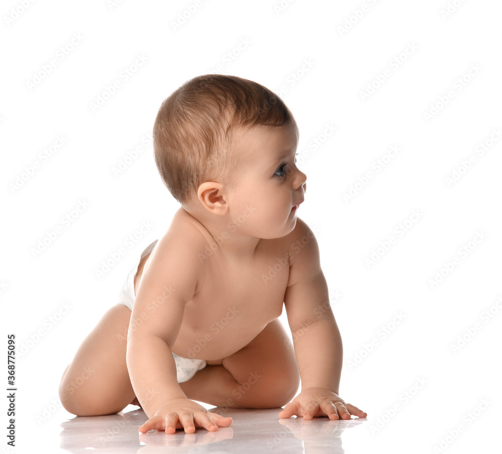 Cute little baby girl infant naked in diaper try to creep on floor looking at the corner isolated on white background Cute little baby girl infant naked in diaper try to creep on floor looking at the corner isolated on white background