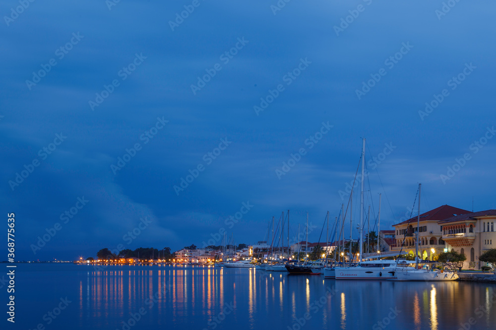 Night view of Preveza town, reflected in the waters of the Ambracian gulf. Epirus, Greece.