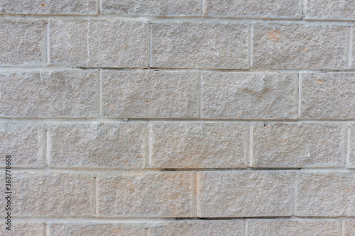 View of old shabby wall made from gray bricks. Abstract textured background. Copy space for your text and decorations.