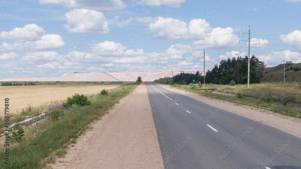 Salt production. Salt piles among the green fields. Salt lake mining of potassium salts. The road to the salt cave. Drone footage of the quarry. Salt production. Salt piles among the green fields. Salt lake mining of potassium salts. The road to the salt cave. Drone footage of the quarry.
