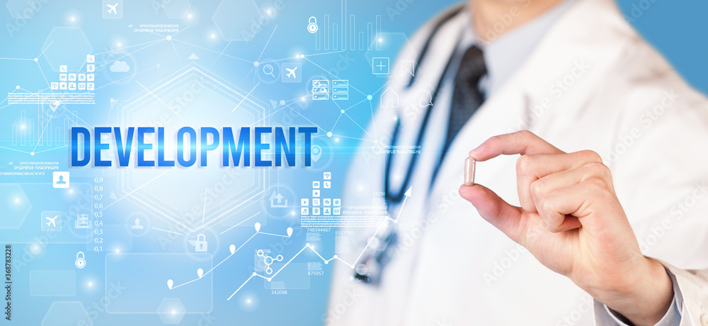Doctor giving a pill with DEVELOPMENT inscription, new technology solution concept Doctor giving a pill with DEVELOPMENT inscription, new technology solution concept