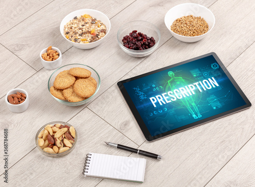 PRESCRIPTION concept in tablet with fruits, top view