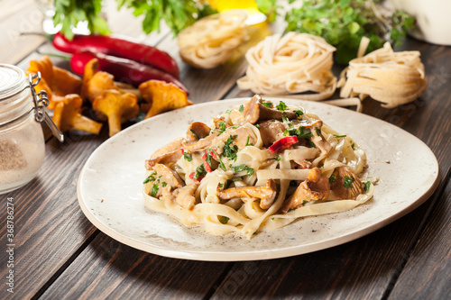 Tagliatelle pasta with chicken and chanterelles mushrooms
