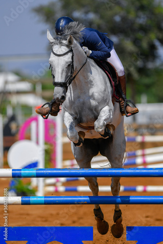 Rider jumps over obstacles during horse show jumping © PROMA