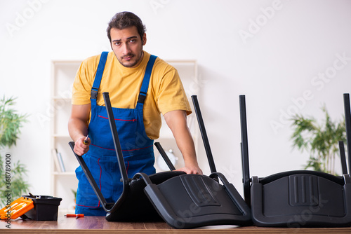 Young male carpenter working indoors