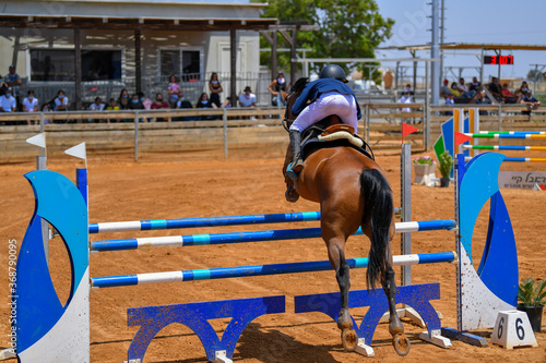 Rider jumps over obstacles during horse show jumping