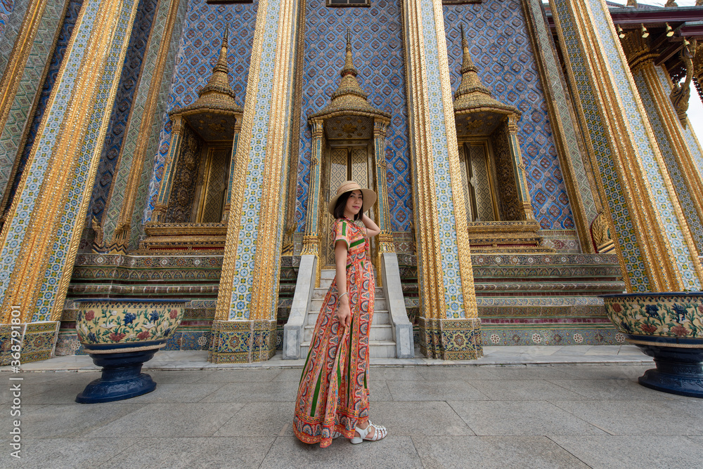 Asian women tourist traveling at Wat Phra Kaew or Wat Phra Si Rattana Satsadaram or Temple of the Emerald Buddha, Bangkok, Thailand, Traveler and Journey trip concept