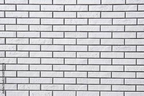 White brick wall background. Textured white clean brick wall  background with copy space. Texture of white wall facade background close up.