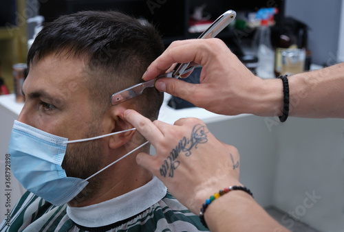 hairdresser cutting hair with razor