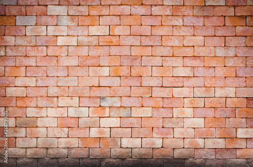 Old orange clay brick wall with crusted stains. Old brick wall texture background  rough surface.There is a copy space to put text.