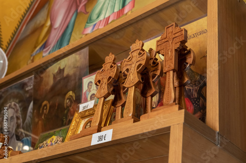 Wooden decorative crosses with crucifixes are sold in the church shop of the Church of the Apostles located on the shores of the Sea of Galilee, not far from Tiberias city in northern Israel