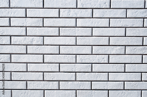 White brick wall background. Textured white clean brick wall, background with copy space. Texture of white wall facade background close up.