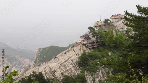 Tourists climbing magnificent Mount Hua or Huashan, a mountain near city of Huayin in Shaanxi, about 120 km east of Xi'an. One of 5 Great Mountains of China with long history of religious significance photo