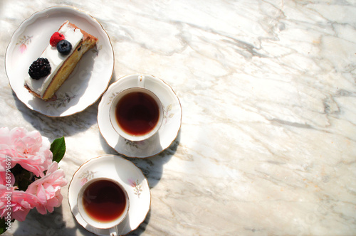 two cups of tea and cake on the marble background