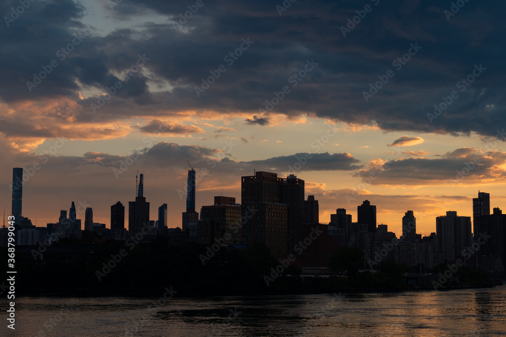 Manhattan Skyline Silhouette along the East River during Sunset in New York City