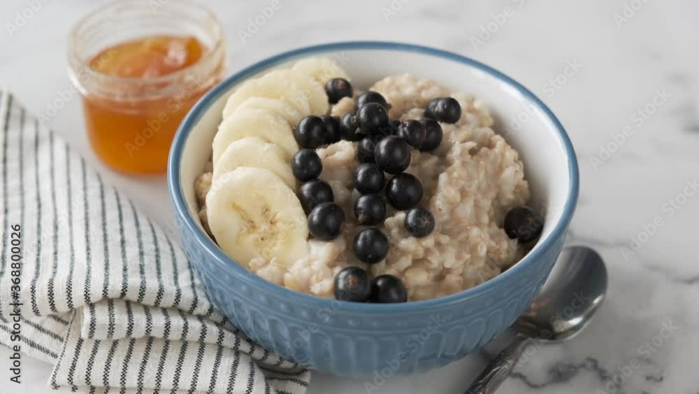 Breakfast oatmeal bowl with banana and acai berries. Healthy breakfast food Breakfast oatmeal bowl with banana and acai berries. Healthy breakfast food