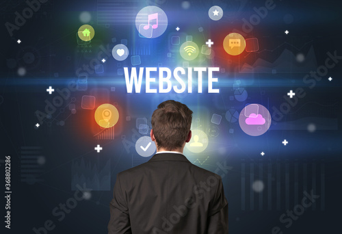 Rear view of a businessman with WEBSITE inscription, modern technology concept
