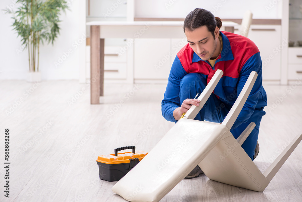 Young male carpenter working indoors Young male carpenter working indoors