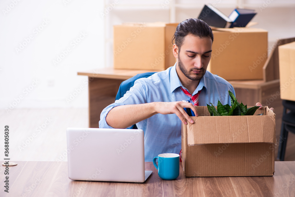 Young male employee in relocation concept Young male employee in relocation concept