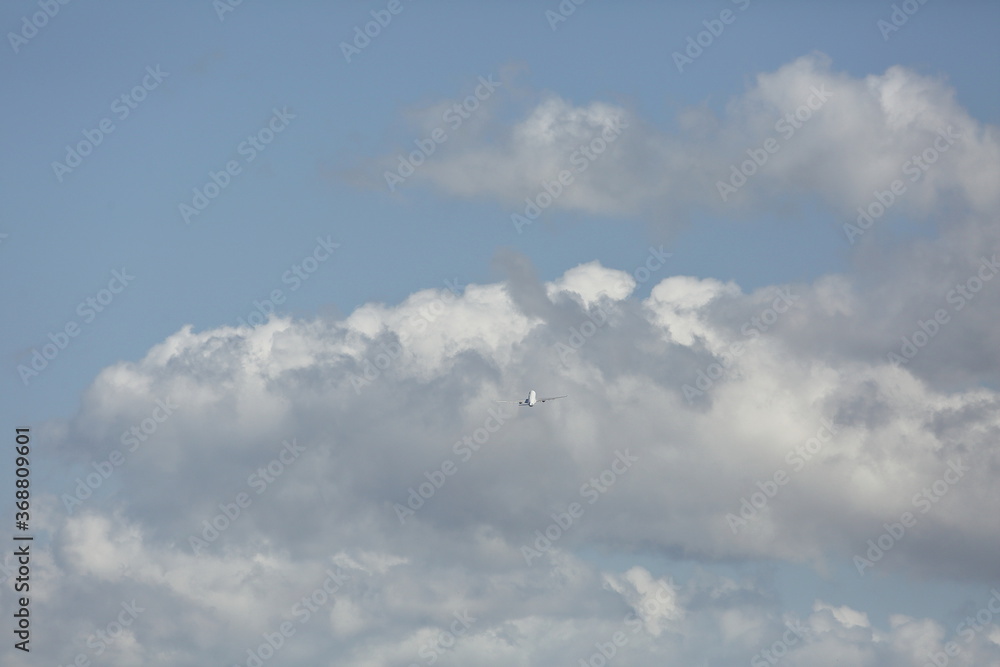 an airplane flying in the sky with cloud an airplane flying in the sky with cloud