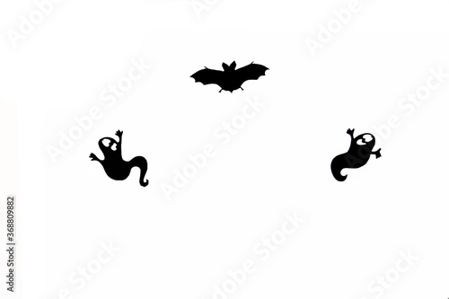 halloween silhouettes - ghosts and a bat against white background flat lay. Halloween concept