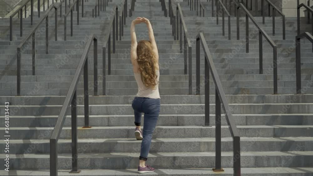 long shot 4K. Young girl contemporary dancer dancing on the steps on an industrial background. straight lines video. long shot 4K. Young girl contemporary dancer dancing on the steps on an industrial background. straight lines video.