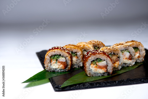 Sushi roll black dragon. Salmon, eel, Philadelphia cheese, shrimp, cucumber.