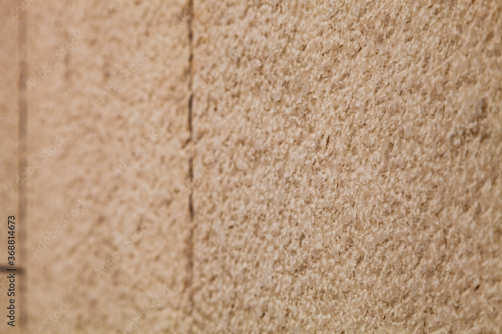 Fototapeta premium Brown stone wall, close-up background.