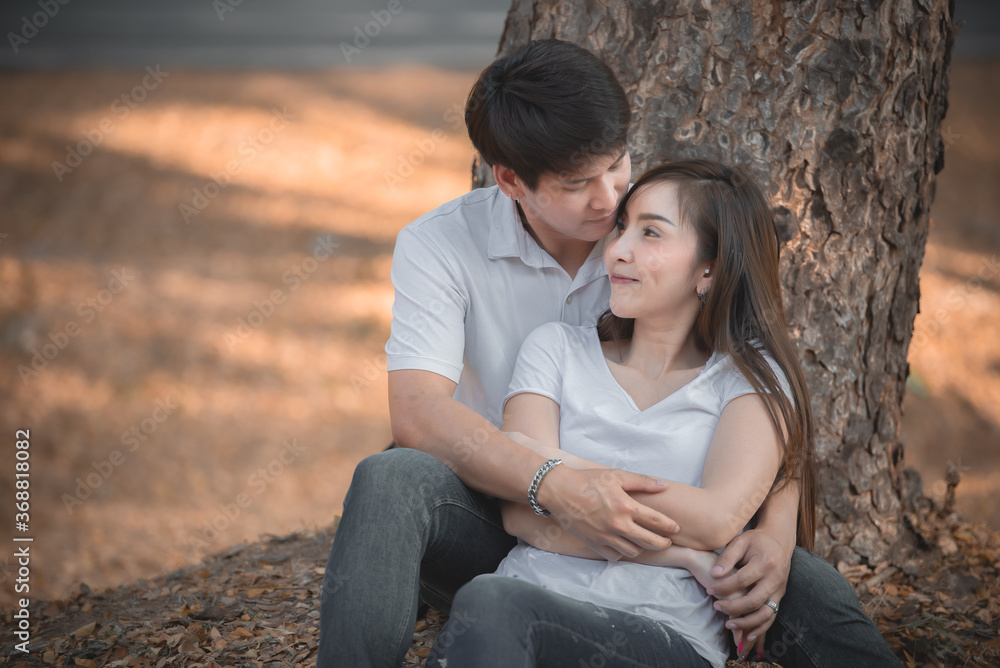 Portrait of young asian couple in love in the forest,Thailand people happy to be together,Valentine day concept Portrait of young asian couple in love in the forest,Thailand people happy to be together,Valentine day concept