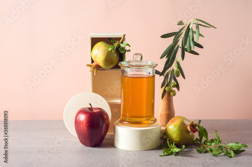 Jewish holiday Rosh Hashana background with honey, pomegranate and red apples. Modern still life composition