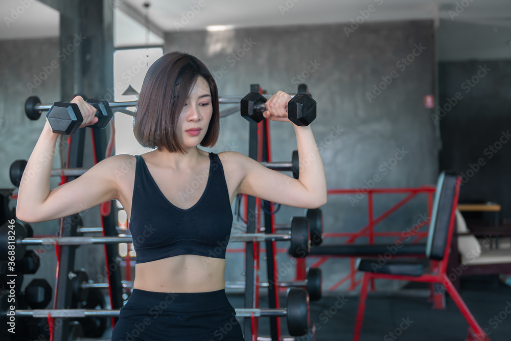 Beautiful asian woman play fitness in the gym,Thailand girl has a slim body,Time for exercise,People love heath,Stretching body before workout,Sport woman warm up body,push up with dumbell Beautiful asian woman play fitness in the gym,Thailand girl has a slim body,Time for exercise,People love heath,Stretching body before workout,Sport woman warm up body,push up with dumbell
