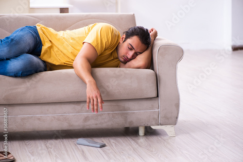 Young man watching tv at home