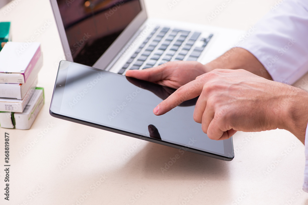 Young male doctor in telemedicine concept Young male doctor in telemedicine concept