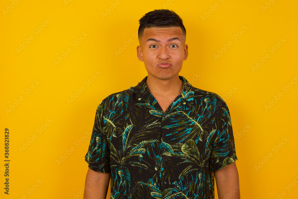 custom made wallpaper toronto digitalPleasant looking young blue eyed male with blond hair, keeps lips as going to kiss someone, has glad expression, grimace face. Standing indoors. Beauty concept.