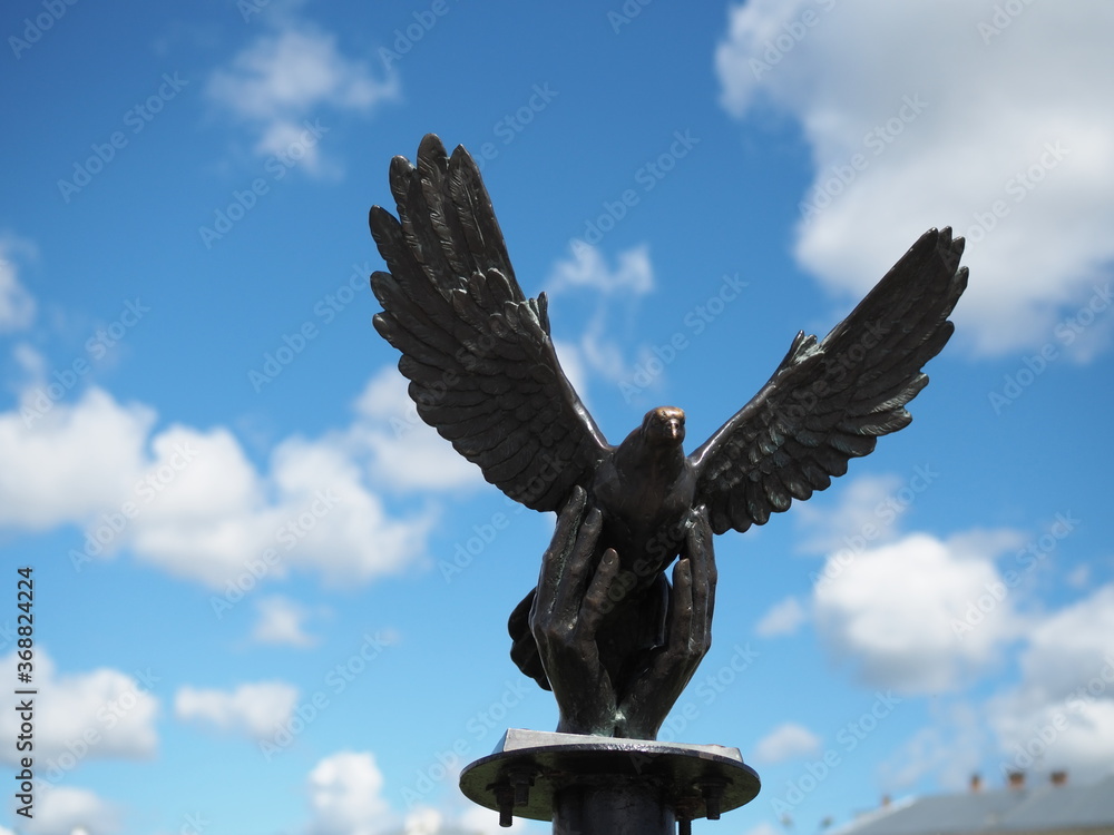 the dove monument of Kostroma, Russia. Statue of a dove in the palms. The dove is a symbol of peace.