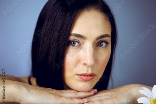 Portrait of smiling brunette woman looking at camera. Beauty concept
