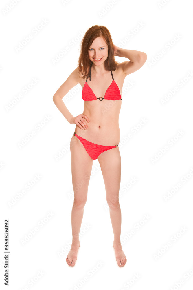 Portrait of a beautiful barefoot woman wearing a red bikini, isolated on white studio background Portrait of a beautiful barefoot woman wearing a red bikini, isolated on white studio background