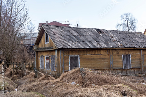Old shabby abandoned wooden house amid devastation and neglect